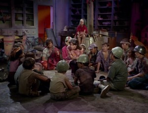 Miri (Kim Darby) plots with the children, as Kellie looks on.