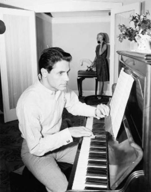 Ken at home and at the piano while wife, Marilyn, takes a call (Photographer: Laurie Richards. Susie Gamble private collection).